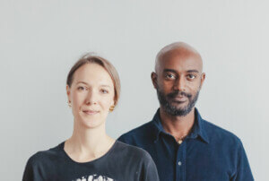 Headshots of a woman and a man on a white background