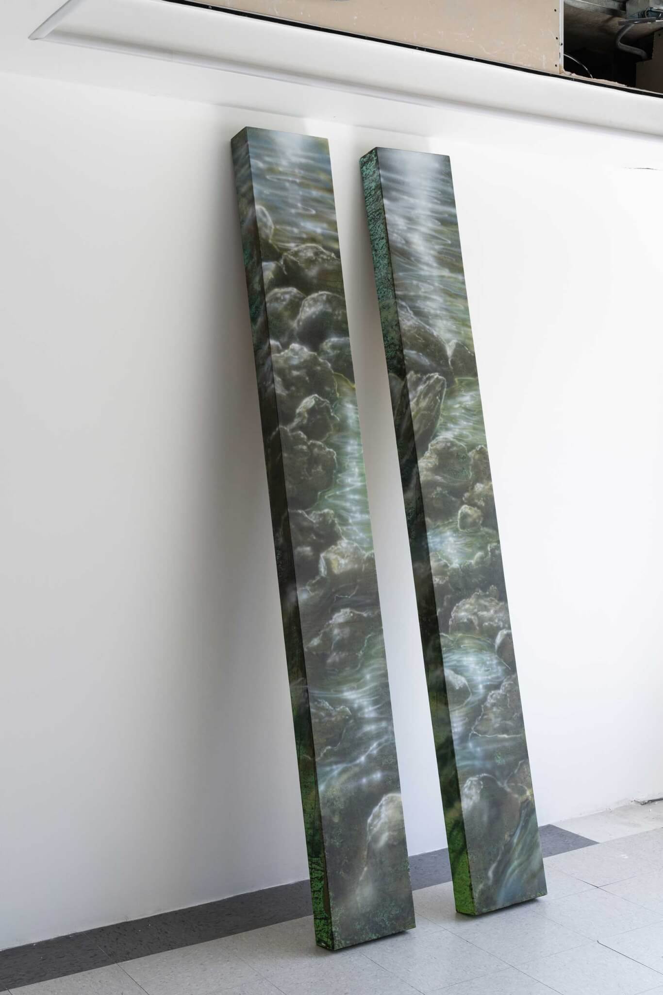 two planks wrapped in green swirl pattern