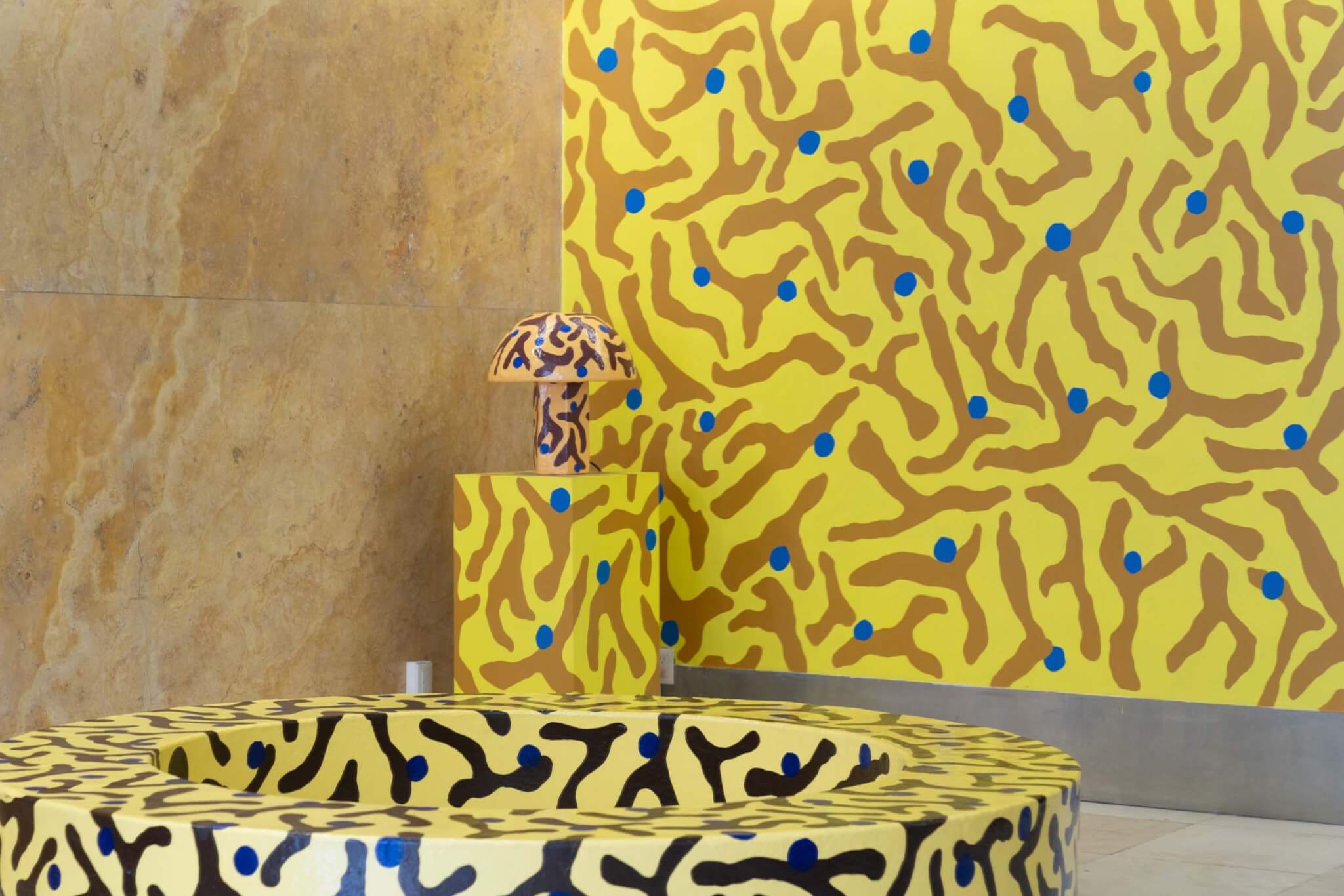 yellow patterned table, lamp, and wall