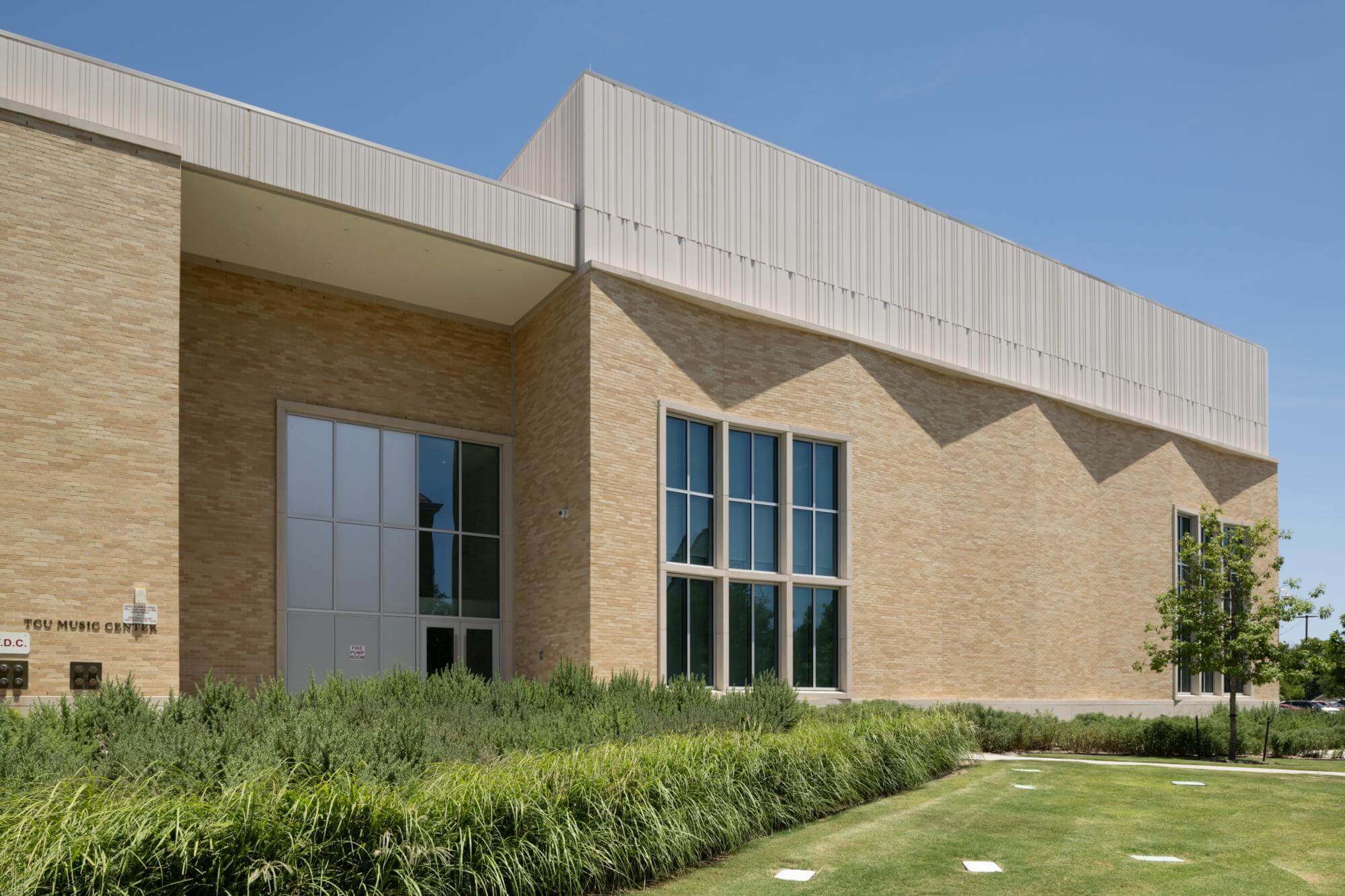 beige brick facade of tcu music center