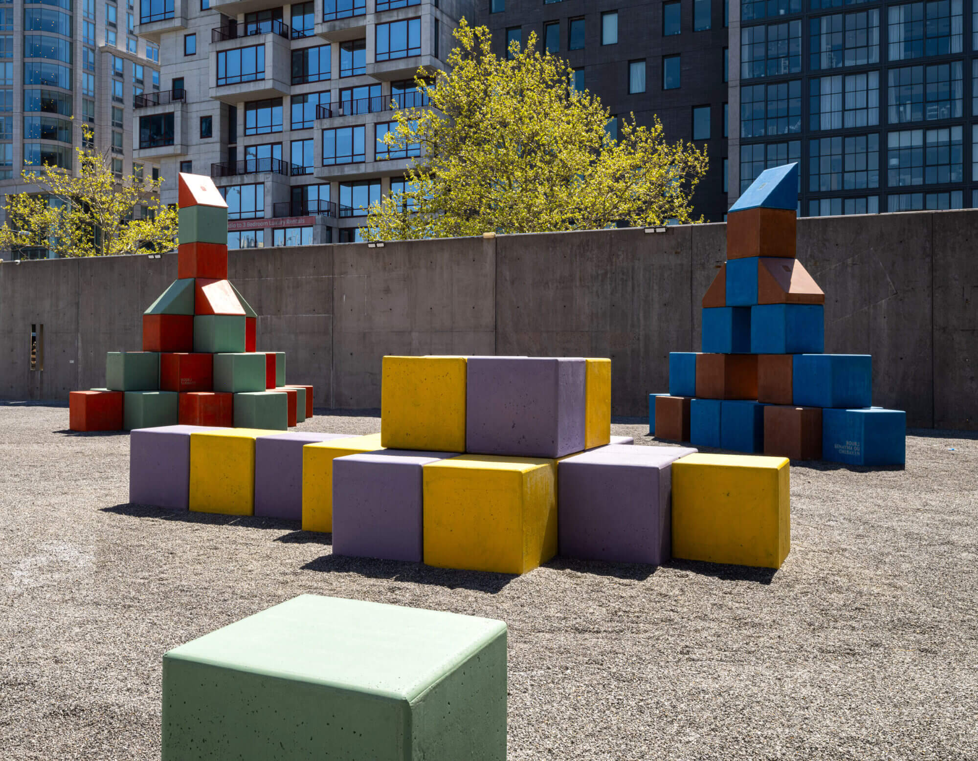 colorful cubes by Yto Barrada on view with buildings in the background