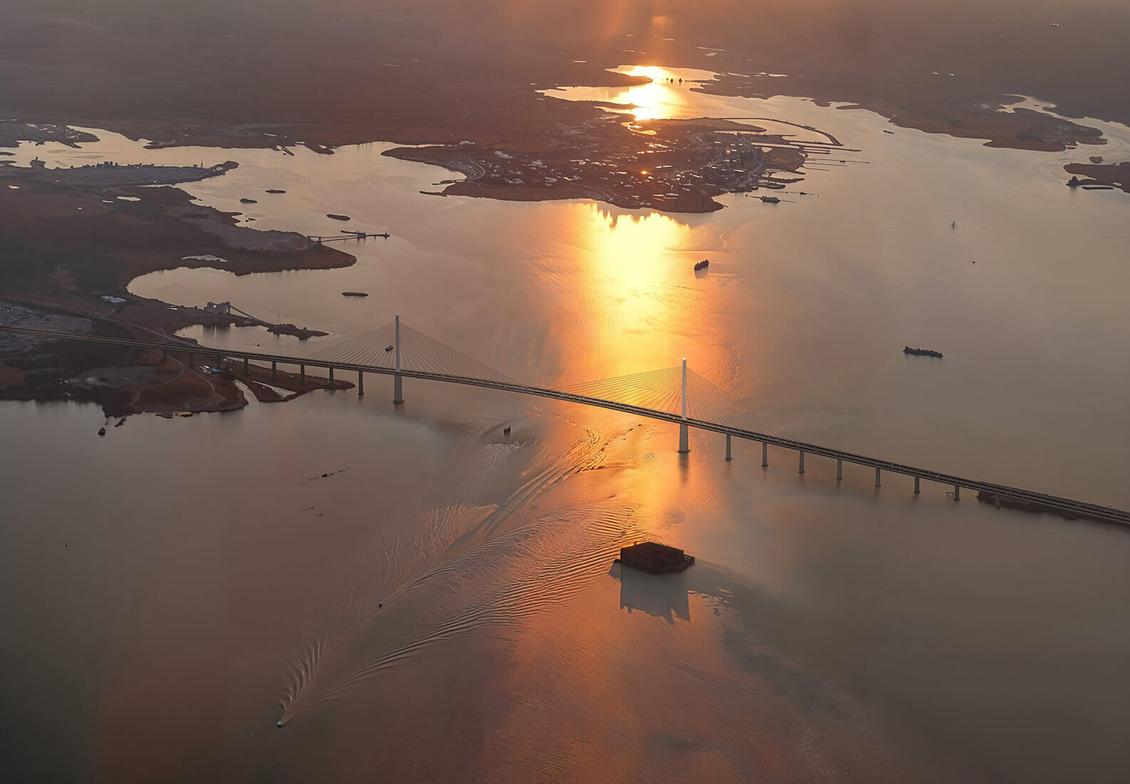 sunlight hitting bridge over water