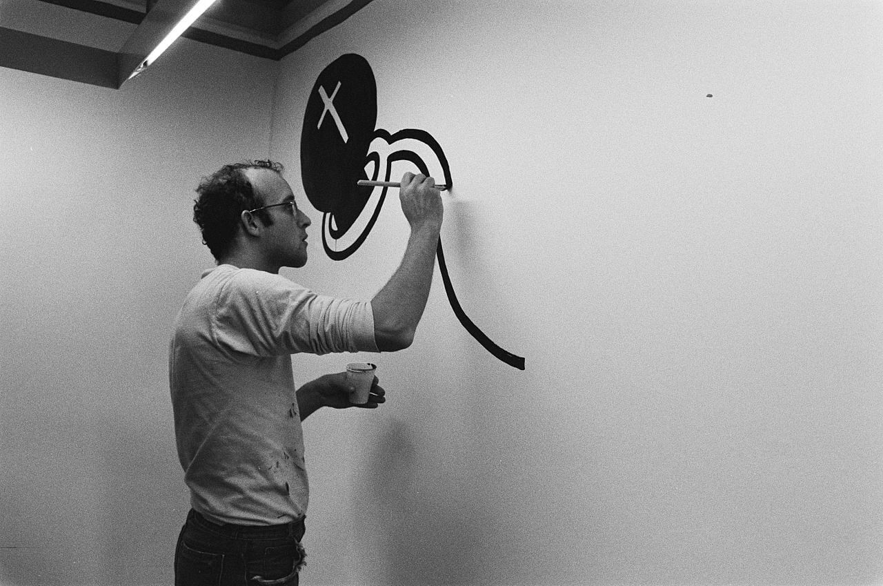 archival image of Keith Haring drawing on a wall
